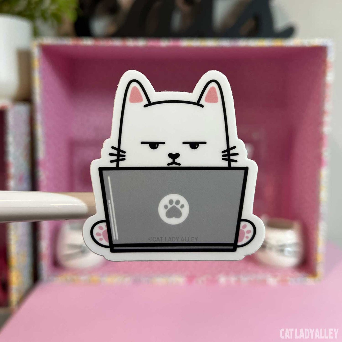 annoyed cat using laptop sticker