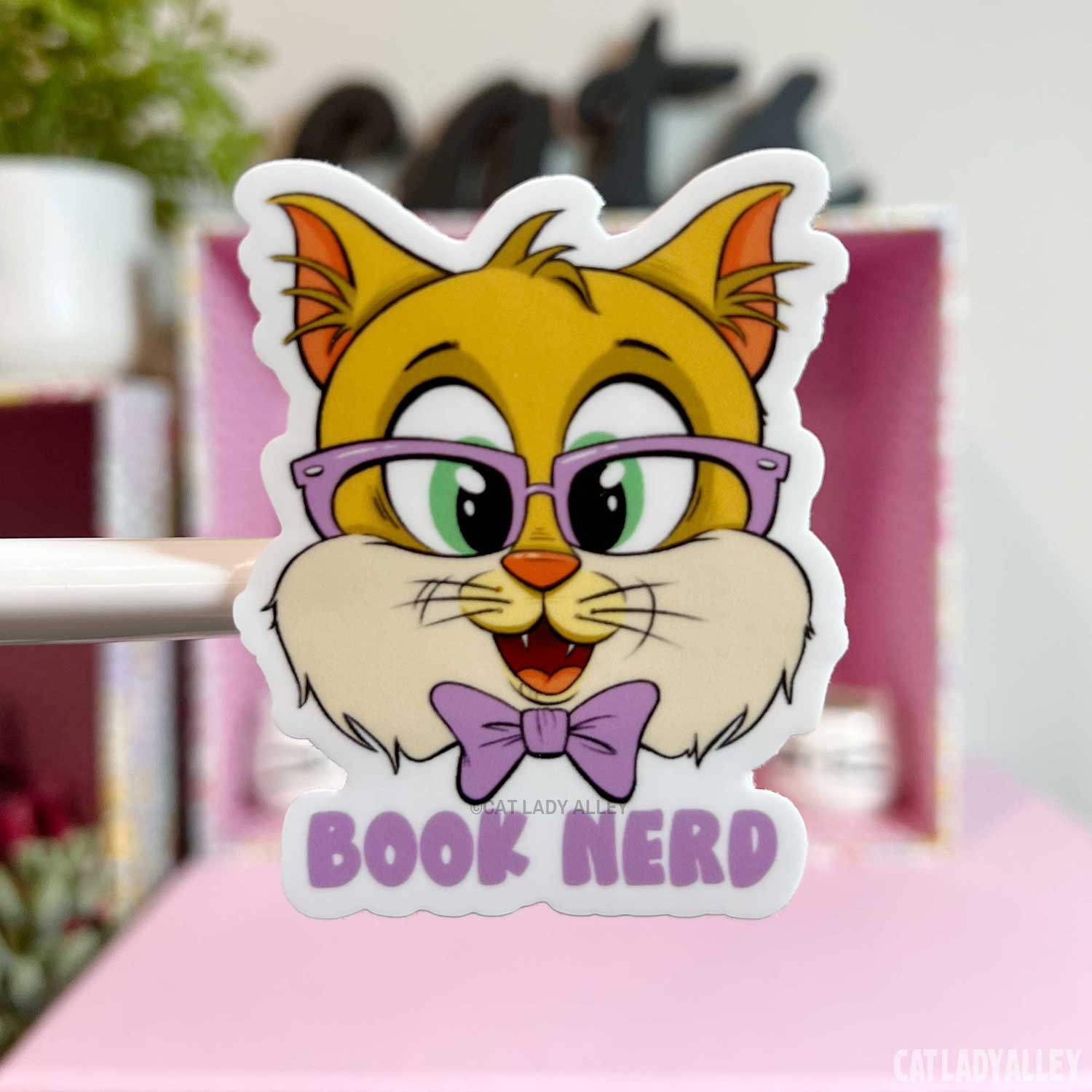 illustrated sticker of ginger cat with book nerd text