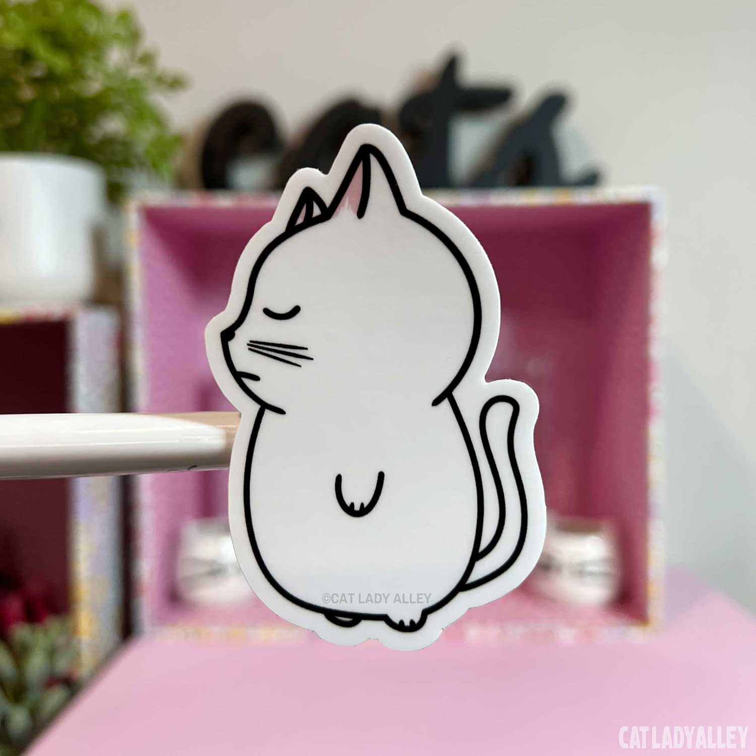 illustrated white cat sticker of sleeping cat