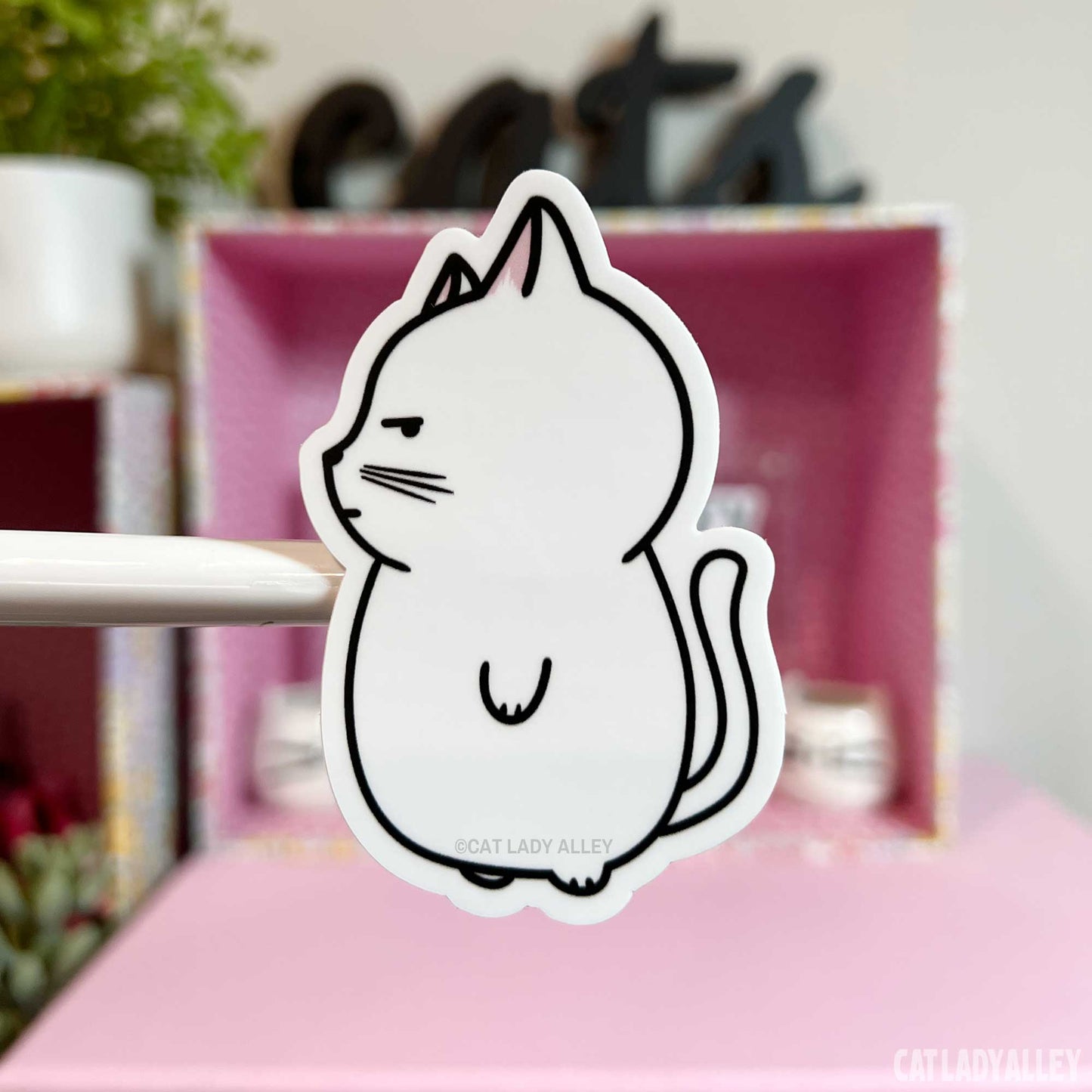 illustrated sticker of white cat with side-eye